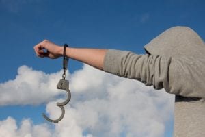 Man with handcuff dangling off of one arm