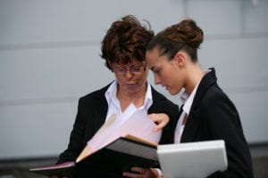 Two female CPS workers reviewing paperwork