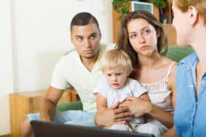 Parents holding child talking to a doctor