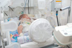 Baby in hospital bed