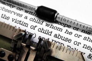 Typewriter with child abuse report being written up