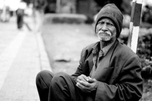Homeless man sitting outside
