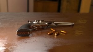 Pistol and ammo sitting on table
