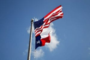 Flag pole with US and Texas flags flying