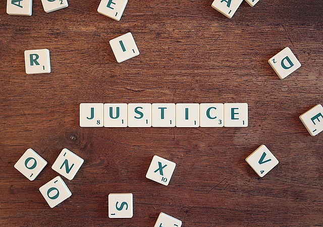 Scrabble pieces spelling "Justice"