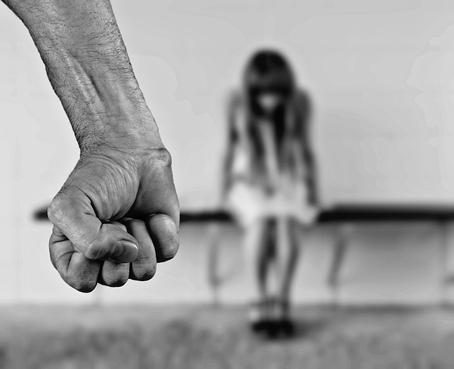 Man clenching fist in front of girl