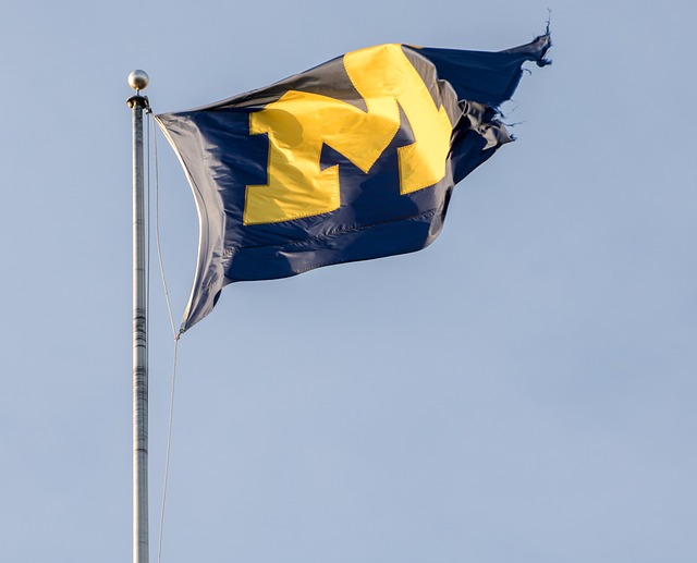 The university of Michigan flag flapping in the breeze.