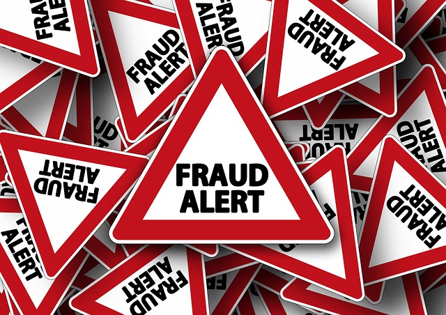 A pile of warning signs saying FRAUD ALERT in big letters.